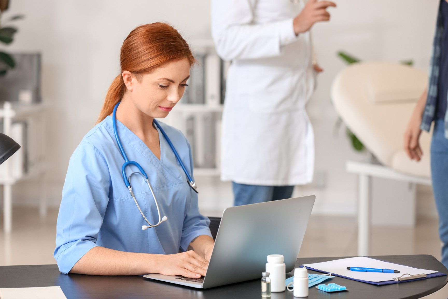 Female Medical Assistant Working in Clinic